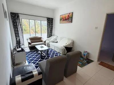a living room with a couch and chairs and a table at AYAAN RAFFLESIA Home at Cameron Highland in Tanah Rata