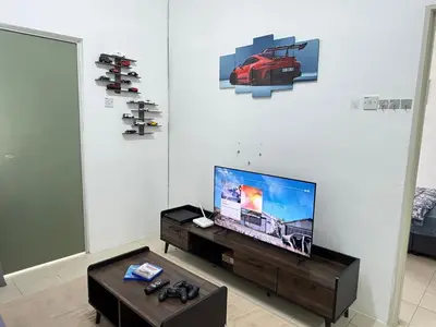 a living room with a flat screen tv and a coffee table at AYAAN GAMING ARENA at Tanah Rata Cameron Highland in Tanah Rata