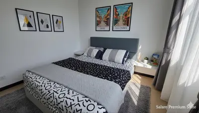 a bedroom with a bed with black and white pillows at Salam Comfy Suite at Bandar Meru Raya Ipoh in Ipoh