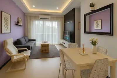 a living room with a table and chairs and a living room at Salam Comfy Suite at Bandar Meru Raya Ipoh in Ipoh