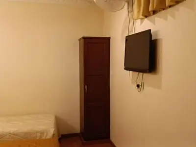 a room with a bed and a tv on a wall at Hotel Remix 2 Cameron Highlands in Gua Sai