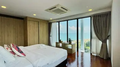 a bedroom with a bed and a large window at Sunrise Gurney Georgetwon in George Town