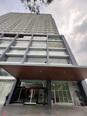 a tall building with a person standing in front of it at Icc ipoh y2 homestay in Ipoh