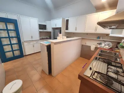a kitchen with white cabinets and a stove top oven at Gurney Vacation Gathering Comfy Home - Solok Burma in George Town