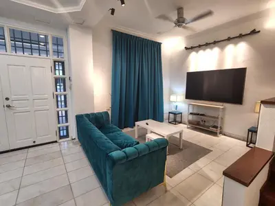 a living room with a couch and a flat screen tv at Gurney Vacation Gathering Comfy Home - Solok Burma in George Town