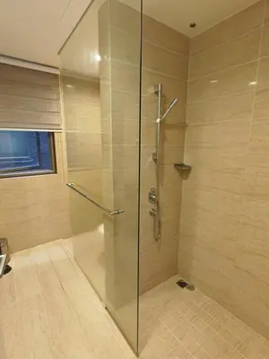 a shower with a glass door in a bathroom at By The Sea Fully Seaview all rooms Beach front in Batu Ferringhi