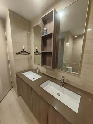 a bathroom with two sinks and a large mirror at By The Sea Fully Seaview all rooms Beach front in Batu Ferringhi