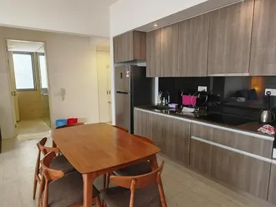 a kitchen with a wooden table and a dining room at By The Sea Fully Seaview all rooms Beach front in Batu Ferringhi