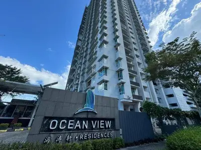 a building with an ocean view sign in front of it at Rainbow Apartment by Renuka in Butterworth