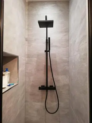 a shower with a shower head in a bathroom at Rainbow Apartment by Renuka in Butterworth