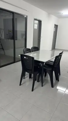 a black table and chairs in a room with glass at Raub Colonial Homestay in Raub