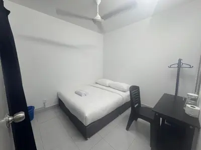 a bedroom with a bed and a chair and a desk at Raub Colonial Homestay in Raub