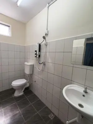 a bathroom with a toilet and a sink at Affordable Nice and Comfortable Room in George Town