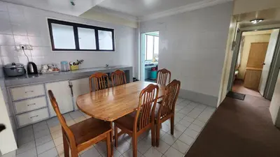 a kitchen with a wooden table and chairs at PAS Homstay CH 2026 in Tanah Rata