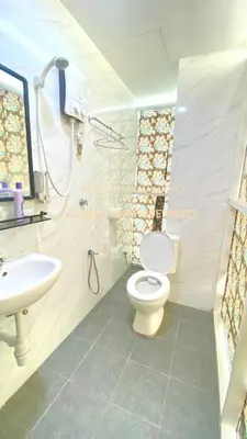 a bathroom with a toilet and a sink at Enviropath Hotel in Gua Sai