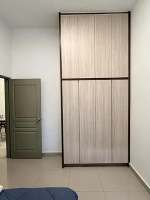 a room with a large wooden closet and a door at Ayaan Snooker Home 5 at Quintet Apartment with Private Parking in Tanah Rata