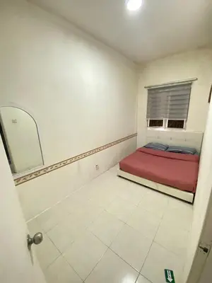 a bedroom with a red bed and a window at Rayyan'Homestay JAYA in Tanah Rata