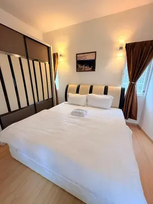 a large white bed in a room with a window at The Nest Retreat, B7-3A-1 2BR Family Suite in Bukit Fraser