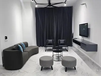 a living room with a couch and chairs and a tv at Seri Ipoh in Ipoh