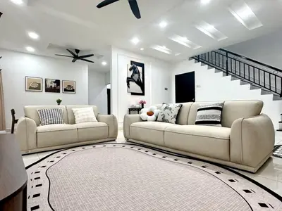 a living room with two couches and a staircase at Spacious Classic 4BR Family Haven I Simpang Ampat in Simpang Ampat