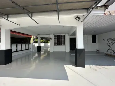 a large room with white walls and a concrete floor at Spacious Classic 4BR Family Haven I Simpang Ampat in Simpang Ampat