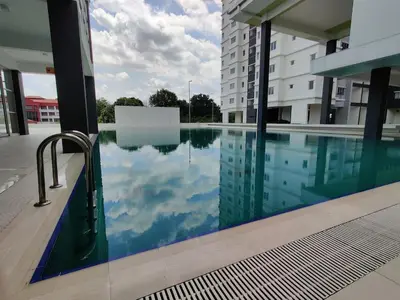 a swimming pool in the middle of a building at Hygge Living Kampar III Near UTAR in Kampar
