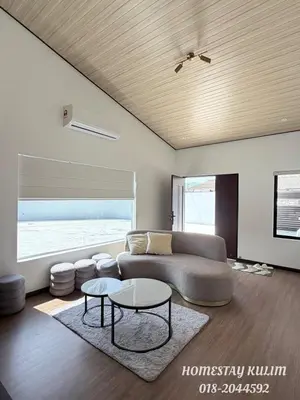a living room with a couch and a table at Stylish Landed Stay in Kulim