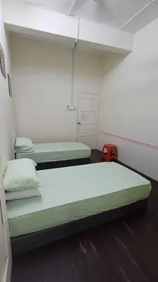 a room with two beds and a red suitcase at POLI Homes in George Town
