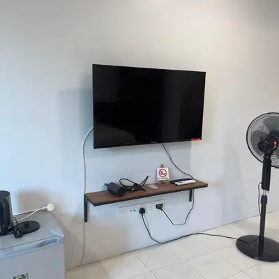a flat screen tv hanging on a wall at pangkor ocean lot10 in Pangkor