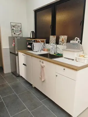 a kitchen with white cabinets and a counter top at IPOH Piccadilly Cozy unit with City View in Ipoh