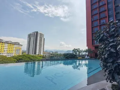 a large swimming pool in front of a tall building at IPOH Piccadilly Cozy unit with City View in Ipoh