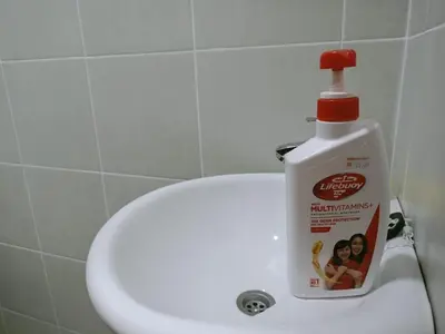 a bottle of mouthwash sitting on the edge of a sink at Kota Emas Homestay -in Sarang Semut, Kedah in Gua Sai