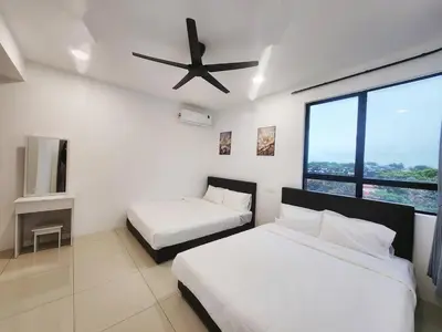 a bedroom with two beds and a ceiling fan at Ipoh Manhattan Condo, Pengkalan 4br12pax in Ipoh