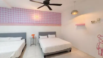 two beds in a room with a ceiling fan at IPOH PRIVATE POOL VILLA 6BR 23pax in Ipoh