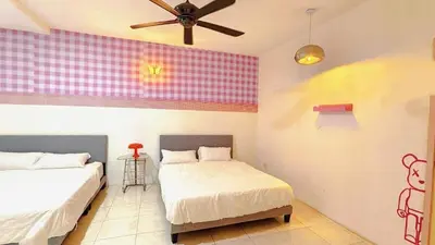a bedroom with two beds and a ceiling fan at IPOH PRIVATE POOL VILLA 6BR 23pax in Ipoh