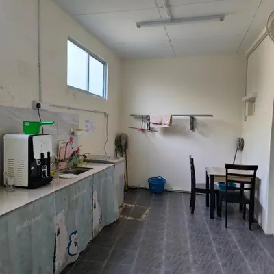 a kitchen with a counter and a table and chairs at POLI Homes in George Town