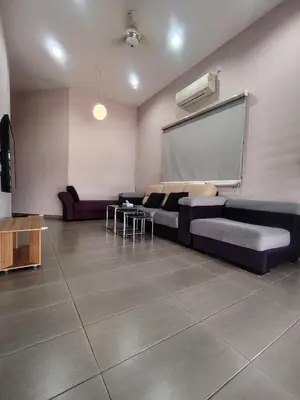 a living room with a couch and a projection screen at Cozy Corner Homestay Bandar Utama Gua Musang in Gua Musang