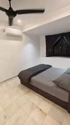 a bedroom with a bed and a ceiling fan at DouDou's House in Simpang Ampat