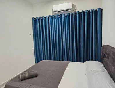 a bedroom with a bed and a blue curtain at Teluk Intan Bajet Homestay Landed 3Bedrooms in Teluk Intan