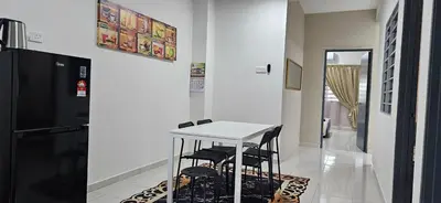 a kitchen with a white table and two black stools at Teluk Intan Bajet Homestay Landed 3Bedrooms in Teluk Intan