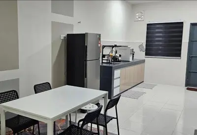 a kitchen with a refrigerator and a table and chairs at Teluk Intan Bajet Homestay Landed 3Bedrooms in Teluk Intan