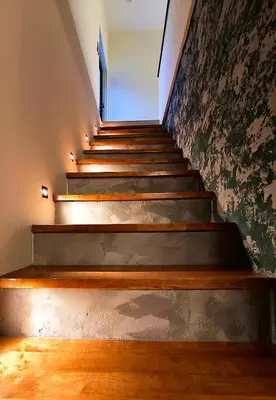 a set of stairs in a building with wooden floors at Deer Farm Pool Villa 5BR 27pax by One Life Four Season Guesthouse in Tanjung Rambutan