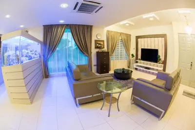 a living room with two couches and a glass table at Ipoh Sky Pool Villa, 20 Pax with Kbox, Gym & BBQ in Ipoh