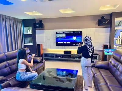 a group of people in a living room playing a video game at Ipoh Sky Pool Villa, 20 Pax with Kbox, Gym & BBQ in Ipoh