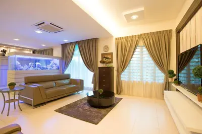 a living room with a couch and a fish tank at Ipoh Sky Pool Villa, 20 Pax with Kbox, Gym & BBQ in Ipoh