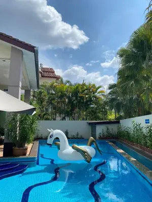 a swimming pool with a white swan in the water at Ipoh Sky Pool Villa, 20 Pax with Kbox, Gym & BBQ in Ipoh