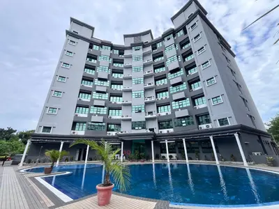 a hotel with a pool in front of it at Stallions Suite Penang in Jelutong