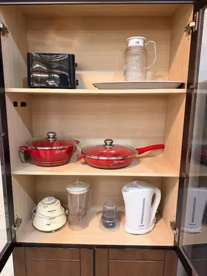 a cupboard with pots and pans and other kitchen items at PRS Bungalow Homestay in Ipoh
