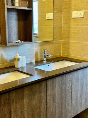 a bathroom with two sinks and a mirror at By The Sea partial seaview 2BR 6pax Batu Ferringhi in Batu Ferringhi