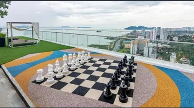 a chess board on the balcony of a building at Wanderlust Retreat 3R by Urban Suites in George Town